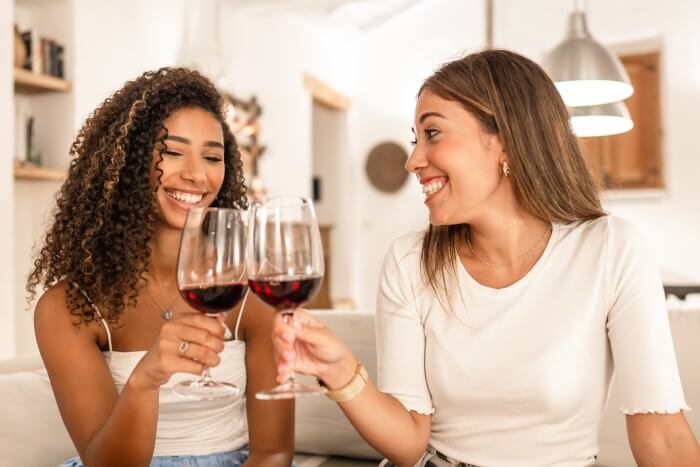 duas mulheres apreciando vinho juntas